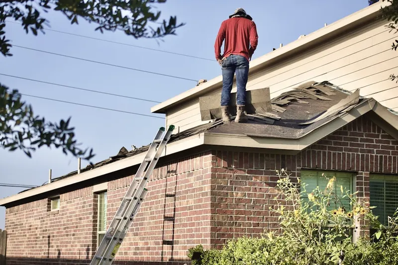 Professional roofer working on a residential roof in Persimmon Grove